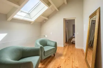 a living room with two chairs and a mirror at Oporto INNside House in Porto