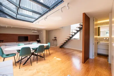 a dining room with a table and green chairs at Oporto INNside House in Porto