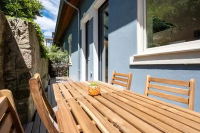 a wooden table with a plant sitting on top of it at Oporto INNside House in Porto