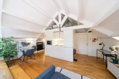 a living room with a couch and a bed at Mercadores Apartment by Amber Star Rent in Porto
