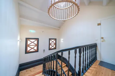 a living room with a large black dresser at Mercadores Apartment by Amber Star Rent in Porto