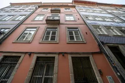 a hallway with stairs leading to a door at Mercadores Apartment by Amber Star Rent in Porto