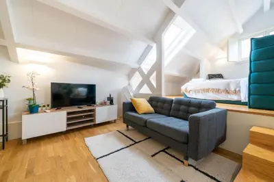 a living room with a couch and a bed at Mercadores Apartment by Amber Star Rent in Porto