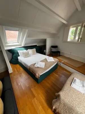 a bedroom with a blue bed with towels on it at Mercadores Apartment by Amber Star Rent in Porto