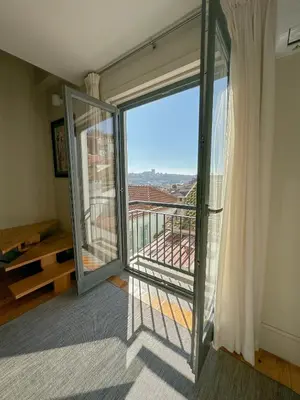 a room with a balcony with a view at My homey at Flores in Porto