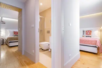 a room with two beds and a hallway with a bedroom at My homey at Flores in Porto