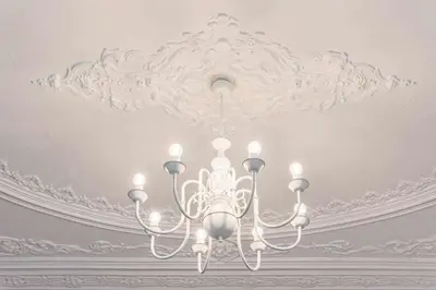 a white chandelier hanging from a ceiling at Classic Bonjardim in Porto