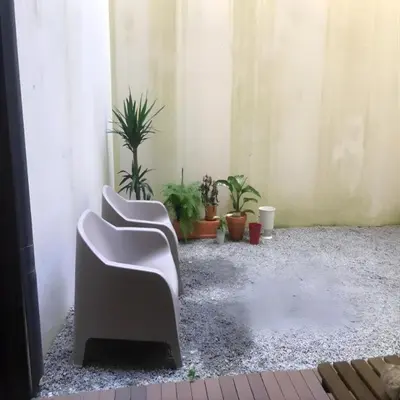 a room with two chairs and potted plants at Pateo Loft in Porto
