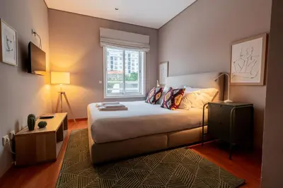 a small bedroom with a bed and a window at Taupe Studio perto do Metro - Cedofeita, Porto in Porto