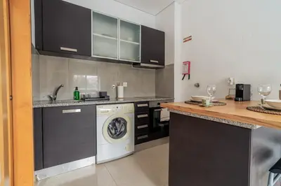 a kitchen with a sink and a dishwasher at Taupe Studio perto do Metro - Cedofeita, Porto in Porto