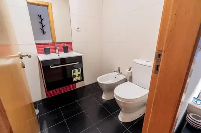 a bathroom with a toilet and a sink at Blue Studio perto do metro - Cedofeita, Porto in Porto