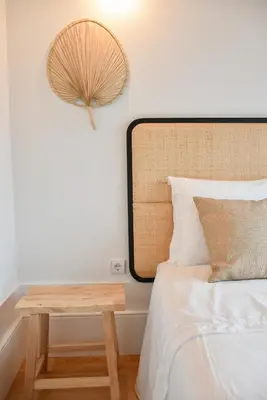 a bedroom with a bed with a table next to it at Charmosa penthouse 2 quartos - Batalha - Porto - APT N in Porto
