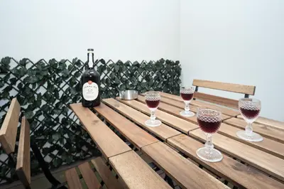 a bottle of wine sitting on a wooden table with wine glasses at Porto XL in Porto