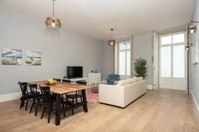 a living room with a table and a white couch at Porto XL in Porto