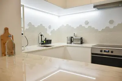 a kitchen with a sink and a counter top at Apartamento central, junto a Praça da Batalha - APT F in Porto