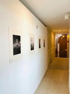 a hallway with pictures on the walls of a building at Lindo apartamento em zona central, Batalha - Porto - APT L in Porto