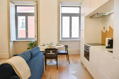 a living room with a blue couch and a table at Apartamento encantador na Batalha - Porto - APT E in Porto