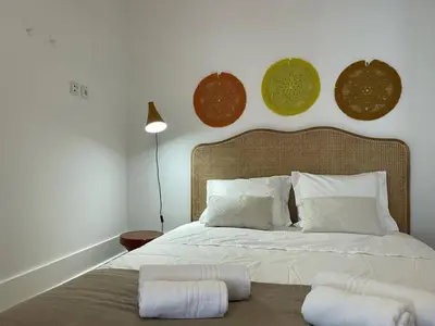 a bedroom with a large bed with two white pillows at Apartamento encantador na Batalha - Porto - APT E in Porto