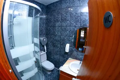 a small bathroom with a toilet and a shower at Travel & Live Nature in Porto