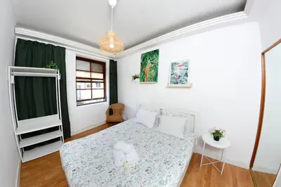 a small bedroom with a bed and a window at Travel & Live Nature in Porto