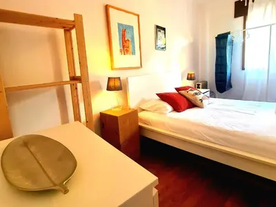 a bedroom with a bunk bed with a table at OHH - Dom Manuel - Central Lounge Apartment in Porto