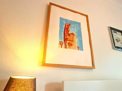 a picture hanging on a wall with a lamp at OHH - Dom Manuel - Central Lounge Apartment in Porto