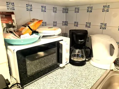 a kitchen counter with a toaster and a microwave at OHH - Dom Manuel - Central Lounge Apartment in Porto