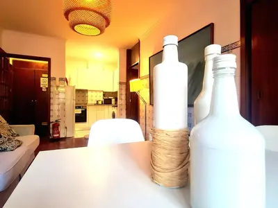 two white bottles sitting on a table in a living room at OHH - Dom Manuel - Central Lounge Apartment in Porto