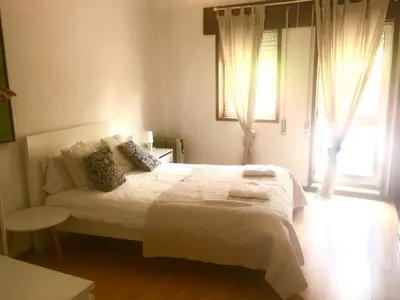 a bedroom with a white bed and a window at OHH - Dom Manuel - Central Lounge Apartment in Porto