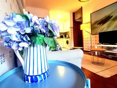 a vase of blue flowers sitting on a table at OHH - Dom Manuel - Central Lounge Apartment in Porto