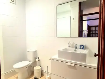 a white bathroom with a toilet and a sink at OHH - Dom Manuel - Central Lounge Apartment in Porto