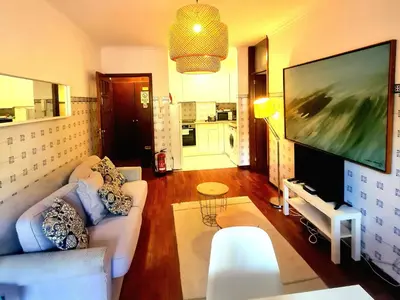 a living room with a large flat screen tv at OHH - Dom Manuel - Central Lounge Apartment in Porto