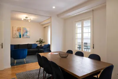 a room with two chairs and a table with a bottle of wine at Invicta Premium - 4BR Downtown apartment with AC in Porto