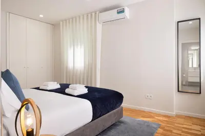 a shower with a glass door in a bathroom at Invicta Premium - 4BR Downtown apartment with AC in Porto