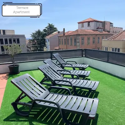 four white chairs sitting on top of a roof at Manuel Apartment - Porto Velho Apt in Porto