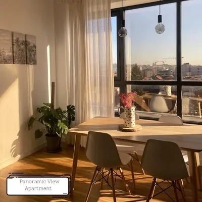 a dining room table with chairs and a large window at Manuel Apartment - Porto Velho Apt in Porto