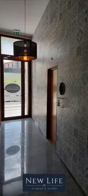 a hallway with a new life sign in a building at New Life - CASA MÚSICA SUITE-2F in Porto