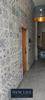 a lobby with a new life sign on a tiled wall at New Life - CASA MÚSICA SUITE-2F in Porto