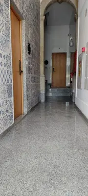 a hallway of a building with a door and a tile floor at New Life - IGREJA SÃO FRANCISCO STUDIO-2T in Porto
