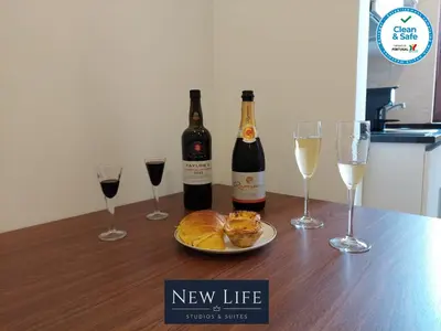 a table with two bottles and two glasses of wine at New Life - IGREJA SÃO FRANCISCO STUDIO-2T in Porto