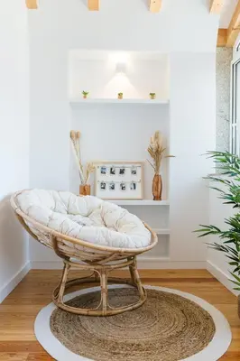 a round white ottoman sitting on a rug in a room at ORM Prado Apartment in Porto