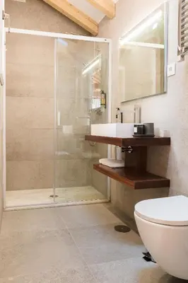 a bathroom with a shower and a toilet and a sink at ORM Prado Apartment in Porto