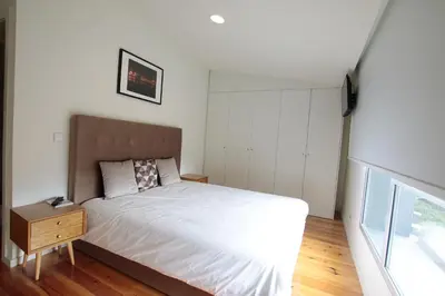 a small bedroom with a bed and a night stand at OPORTO GUEST Natária Flats with Parking in Porto