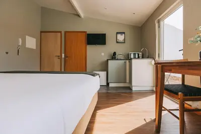 a living room with a bed and a kitchen at Oporto Maison Sol in Porto