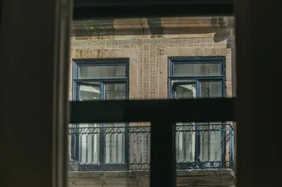 a view of a building through a window at Oporto Maison Sol in Porto
