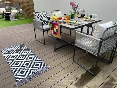 a dining table and chairs with a plate of food on it at Luxury in the Art District by Innkeeper in Porto