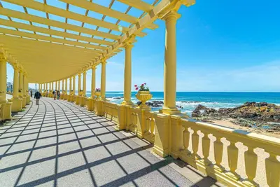 a yellow boardwalk on the beach near the ocean at Luxury in the Art District by Innkeeper in Porto