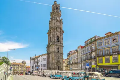 a tall clock tower in a city with buildings at Luxury in the Art District by Innkeeper in Porto