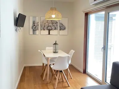a dining room with a white table and chairs at Apartments Porto Historico in Porto