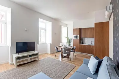 a living room with a blue couch and a table at Monte dos Judeus 26 by LovelyStay in Porto
